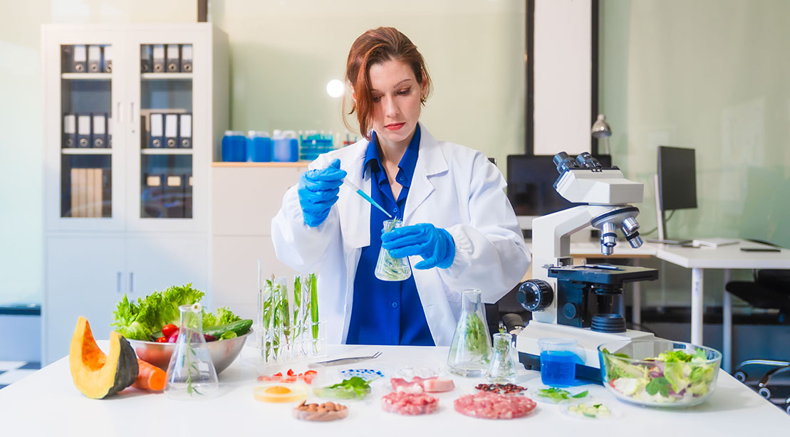 Female scientist testing for food additives in various types of foods in a lab