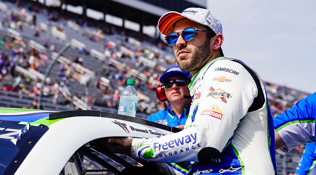 Nascar Racer Daniel Suárez entering his race car at NASCAR